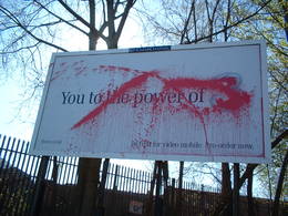 vandalised advert clear channel water pistol red paint united kingdom