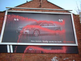 vandalised advert clear channel water pistol red paint united kingdom