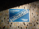 eastville underpass fly poster graffiti evolution of man subverted by fear, bristol, united kingdom (uk).